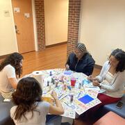 ASL Pod members gathered around a table painting door decorations.